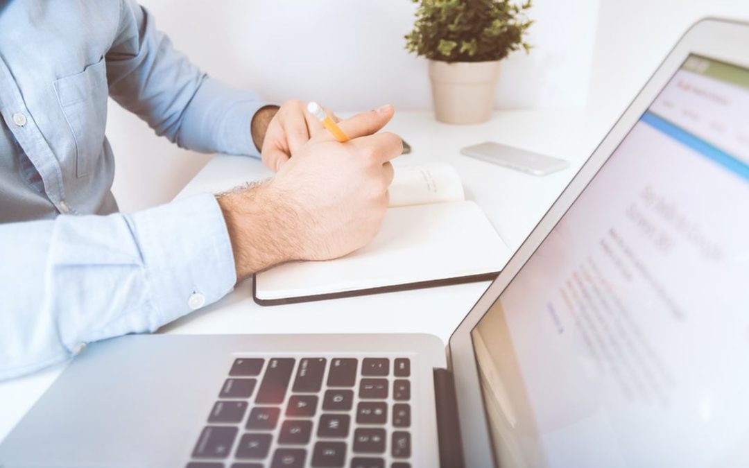 Man working on crm for insurance on his laptop